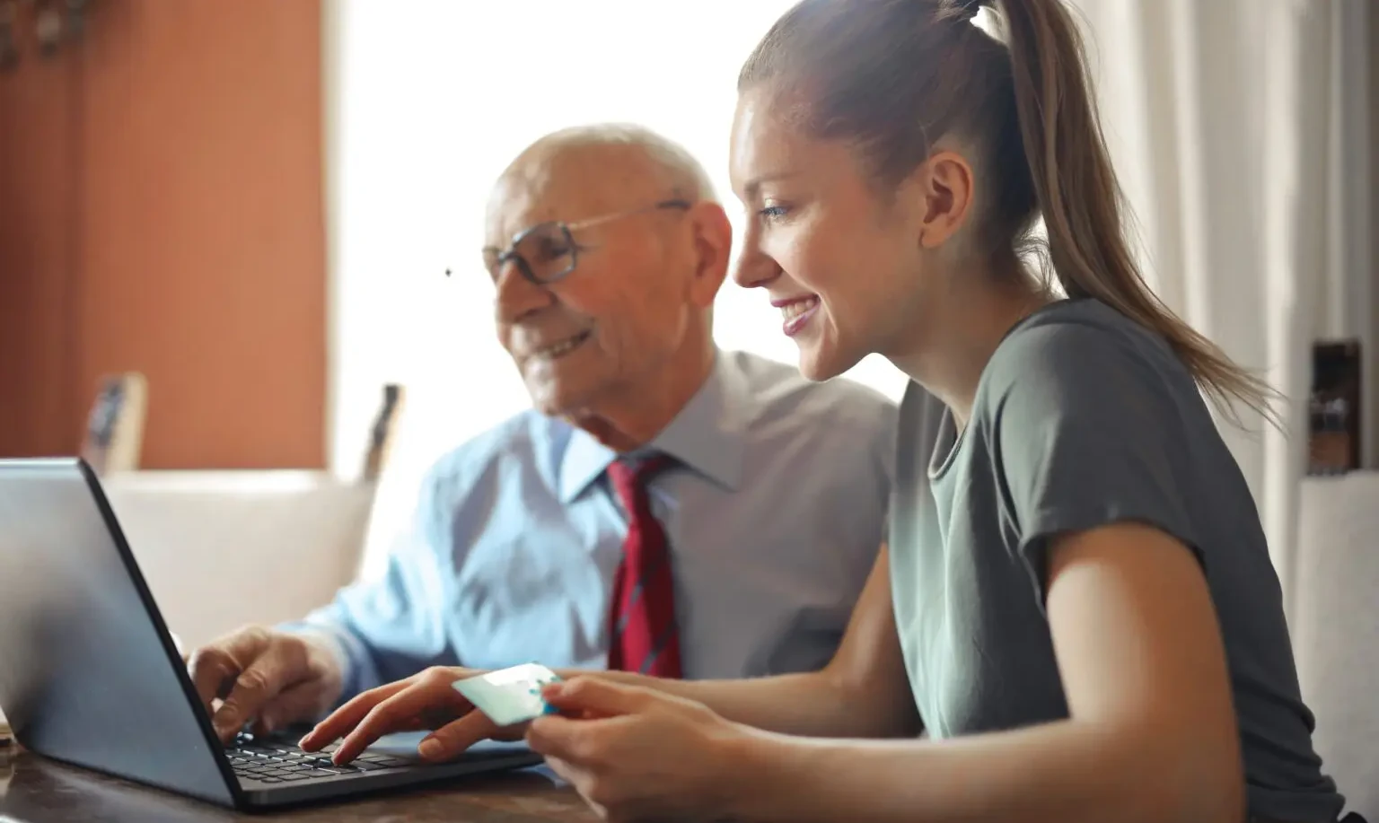 old man and young women with laptop